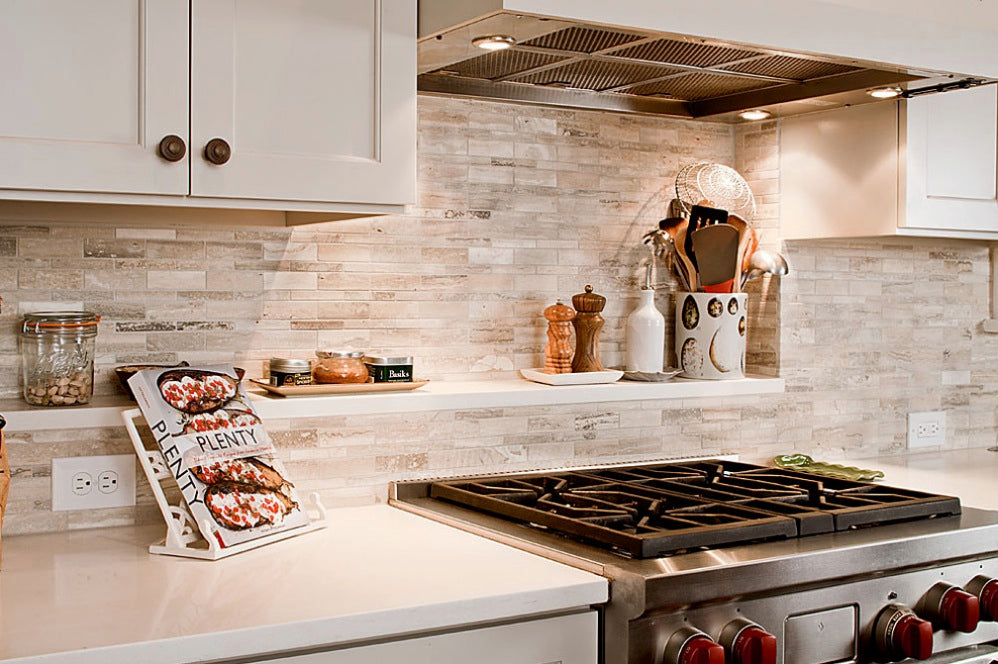 Beautiful kitchen with white subway tile backsplash, white shaker cabinets and quartz countertops