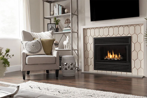 Floor to ceiling tile fireplace surround with herringbone pattern featured on BELK Tile Fireplace Blog